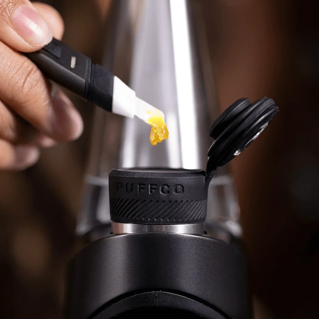 Close-up of the Puffco Hot Knife loading concentrate into a Puffco Peak Pro chamber