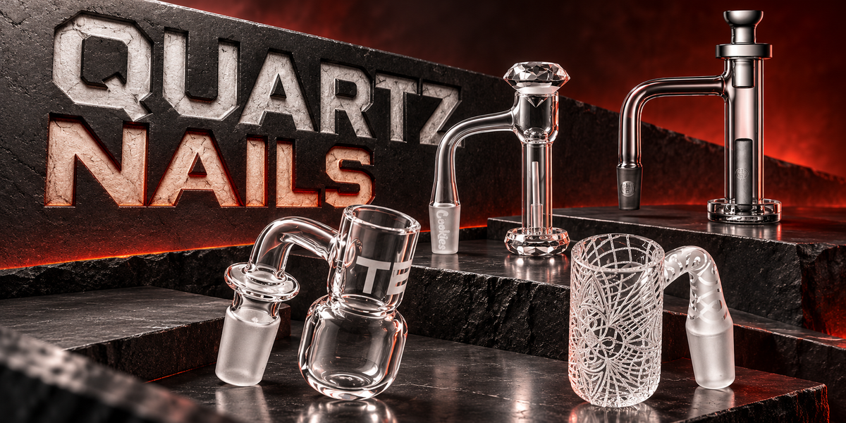 Clear quartz bangers on dark slate with a red glow: flat top, round bottom, engraved and tower-style bangers