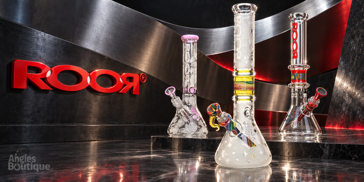 ROOR beaker bongs on steel: a frosted beaker with a rasta band, a clear red-logo beaker and a pink-accent beaker