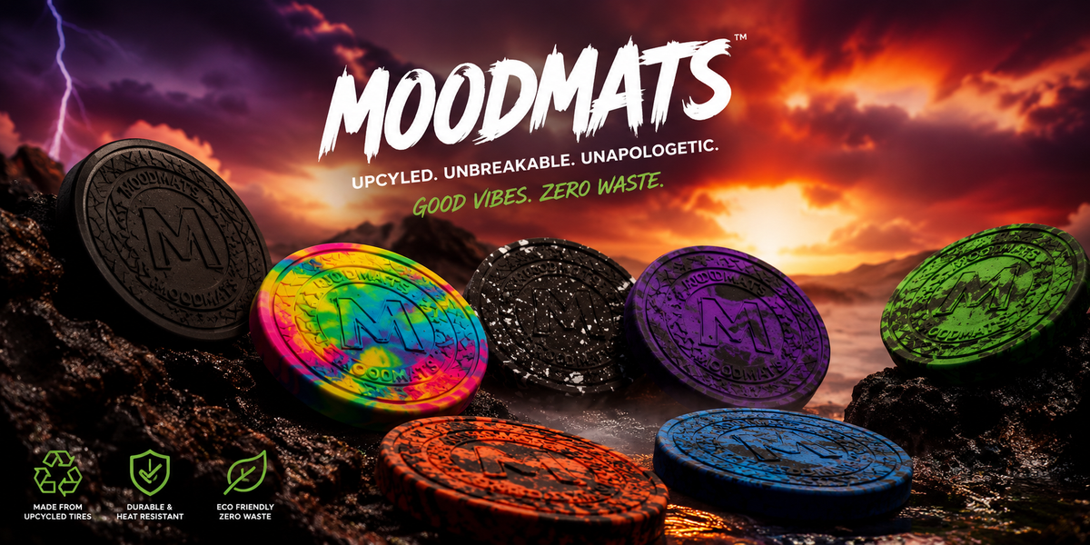 Round Moodmats rubber dab mats in black, rainbow tie-dye, speckled, purple, green, orange and blue on volcanic rock at sunset
