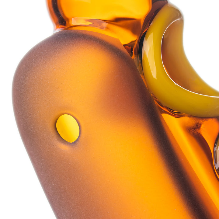 Close-up of the side carb hole on the BigFun! Glizzy Hand Pipe, used for airflow control while drawing