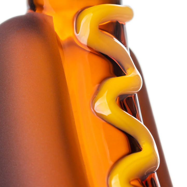 Close detail of the raised mustard swirl on the BigFun! Glizzy Hand Pipe, with the color fused into the borosilicate glass rather than painted on the surface