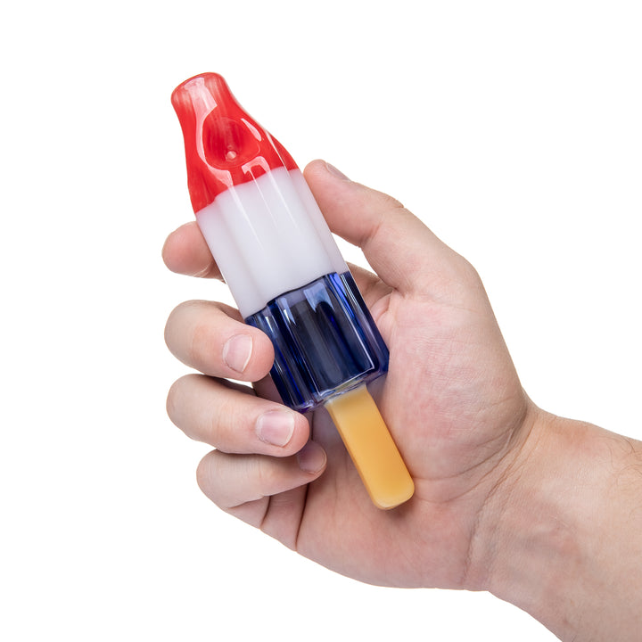 BigFun! Pipesicle Red White Blue held in a hand for scale, showing the 6-inch by 1.5-inch proportions against a standard grip