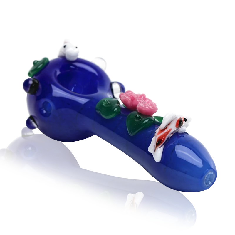 Empire Glassworks Koi Pond Pipe Small – cobalt blue spoon pipe with a white-and-orange koi on the bowl rim, pink lotus flowers and green lily pads