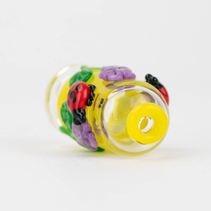 Empire Glassworks Sunshine Garden Pivot Top – laying image showing flower accents and mouthpiece opening.