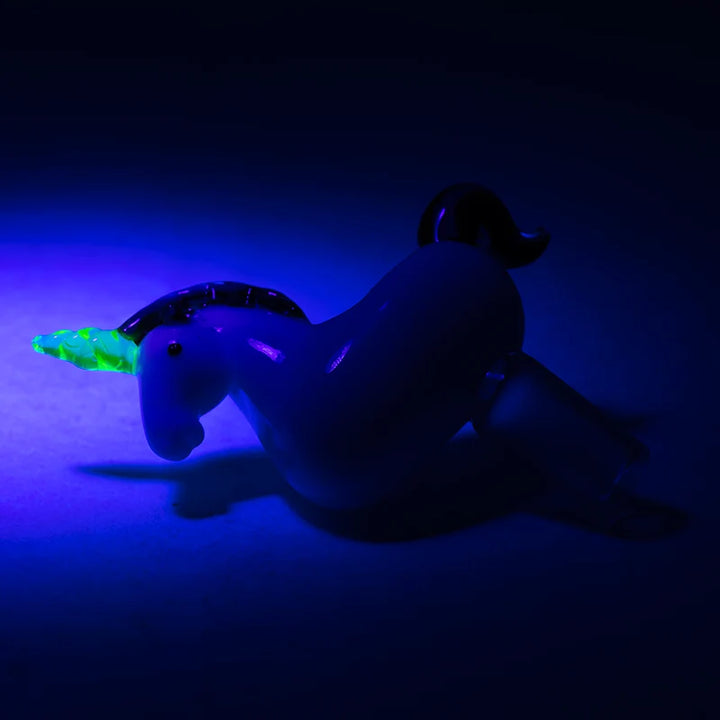 Empire Glassworks Unicorn Slide 14mm under blacklight – UV-reactive horn glowing bright green