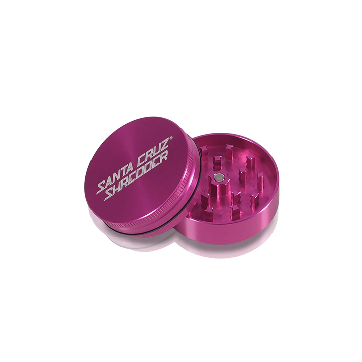 Pink Santa Cruz Shredder 2-Piece Medium Grinder – open view showing anodized aluminum and sharp teeth.