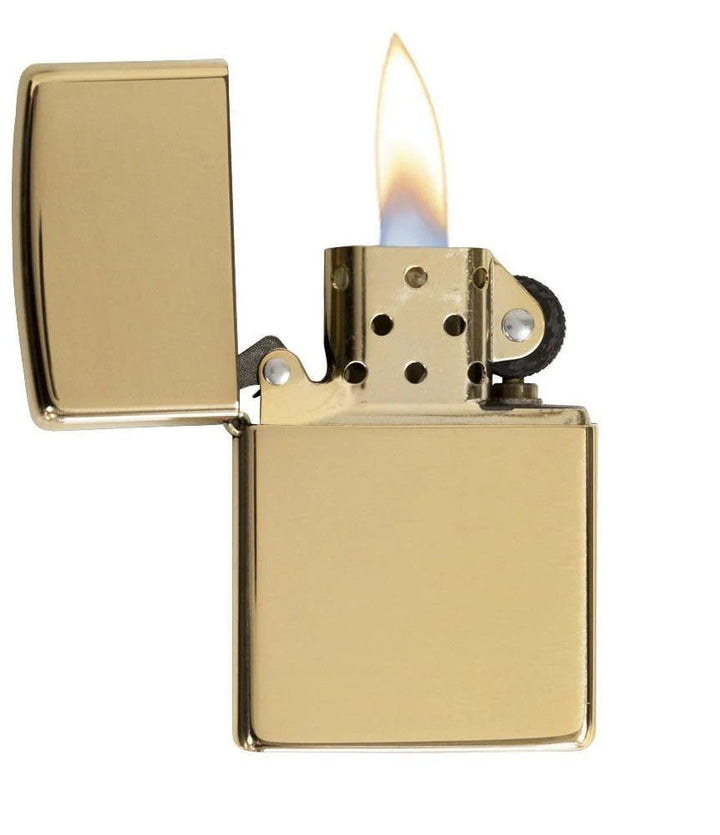 Zippo Brass windproof lighter with high polish finish, open lid and lit flame. Durable, refillable design ideal for everyday use or gifting.