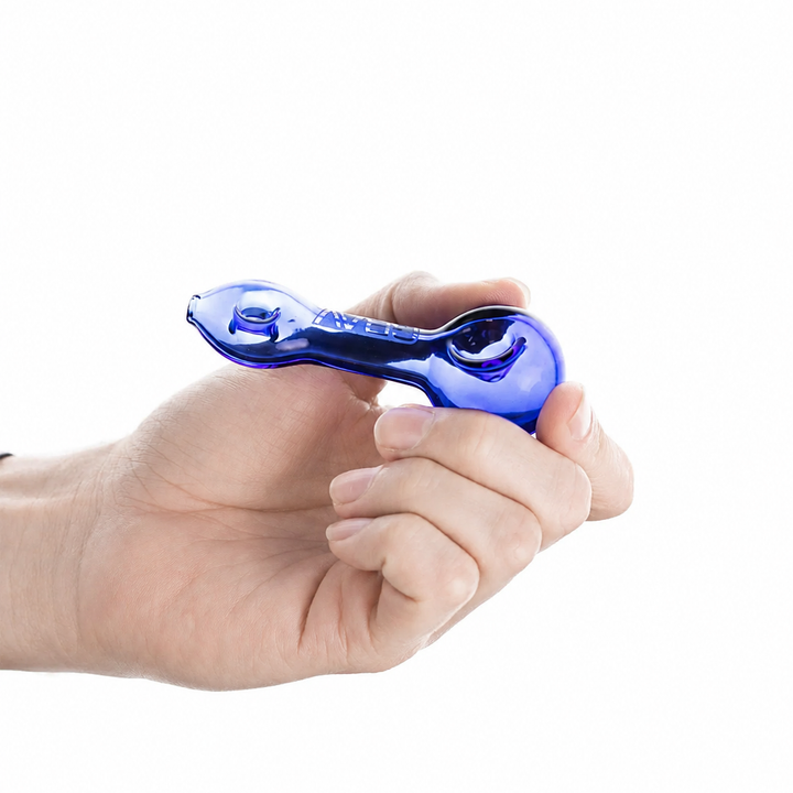 GRAV Mini Spoon held in a hand, showing the 3.25" pocket scale of the glass pipe.
