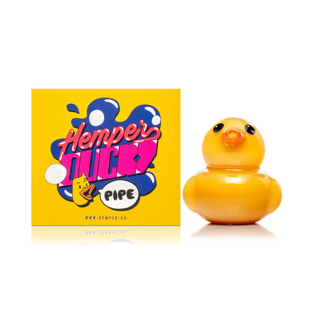 Hemper Ducky Hand Pipe next to its Hemper retail box, showing how the pipe arrives packaged and gift-ready
