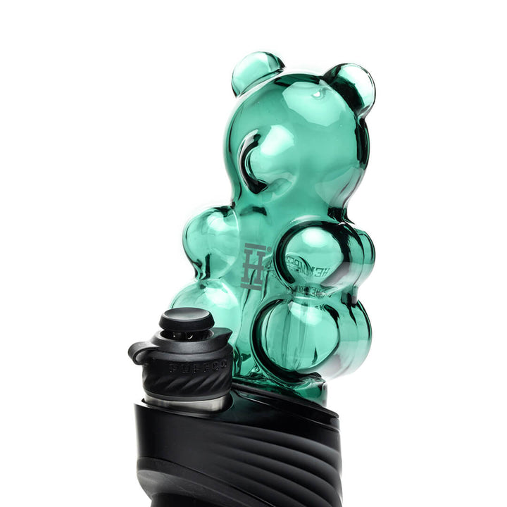Hemper Gummy Bear Peak Top fitted onto a Puffco Peak device at an angle, showing how the attachment sits on the base in use