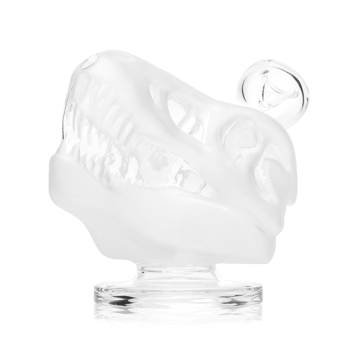 Hemper Jurassic Spark Dinosaur Skull bong in three quarter view on its clear foot