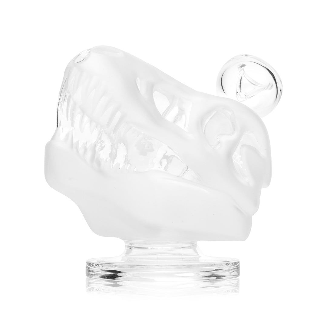 Hemper Jurassic Spark Dinosaur Skull bong in three quarter view on its clear foot