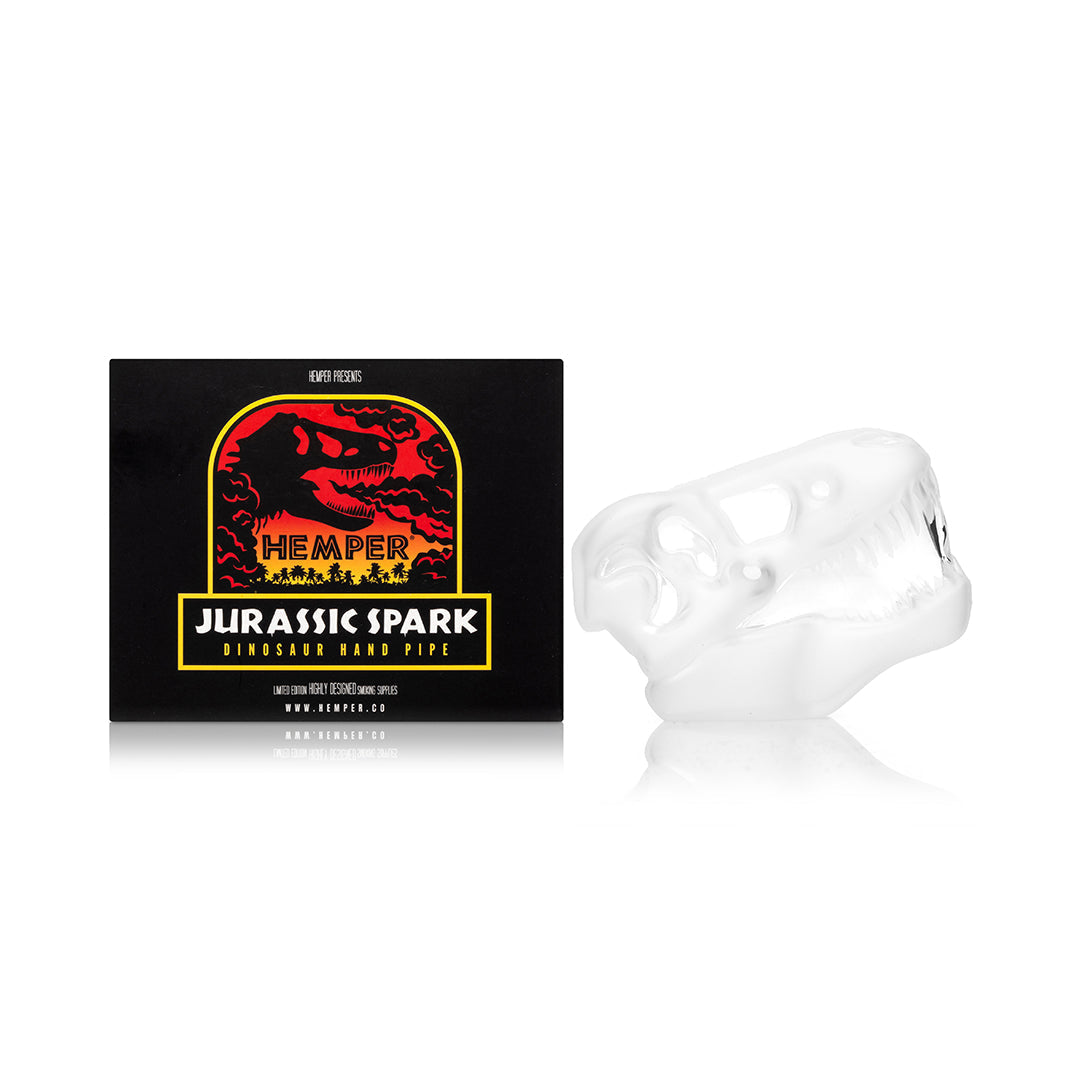 Hemper Jurassic Spark Skull hand pipe beside its printed retail box