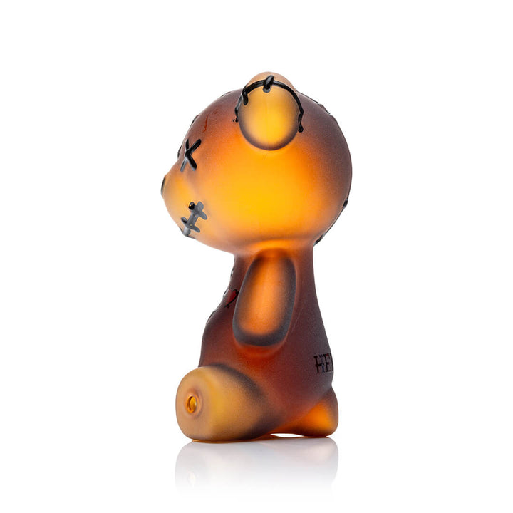 Hemper Scare Bears Teddy Bear hand pipe at an angle, amber glass fading to gold