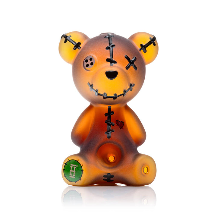 Hemper Scare Bears Teddy Bear hand pipe in amber glass with stitched-eye detailing