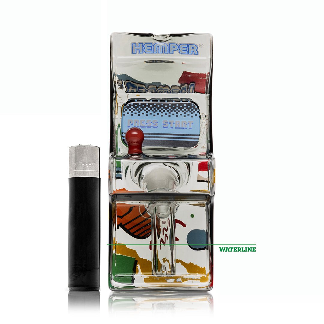Hemper Totally Rad Arcade bong with the recommended waterline marked, shown with a lighter