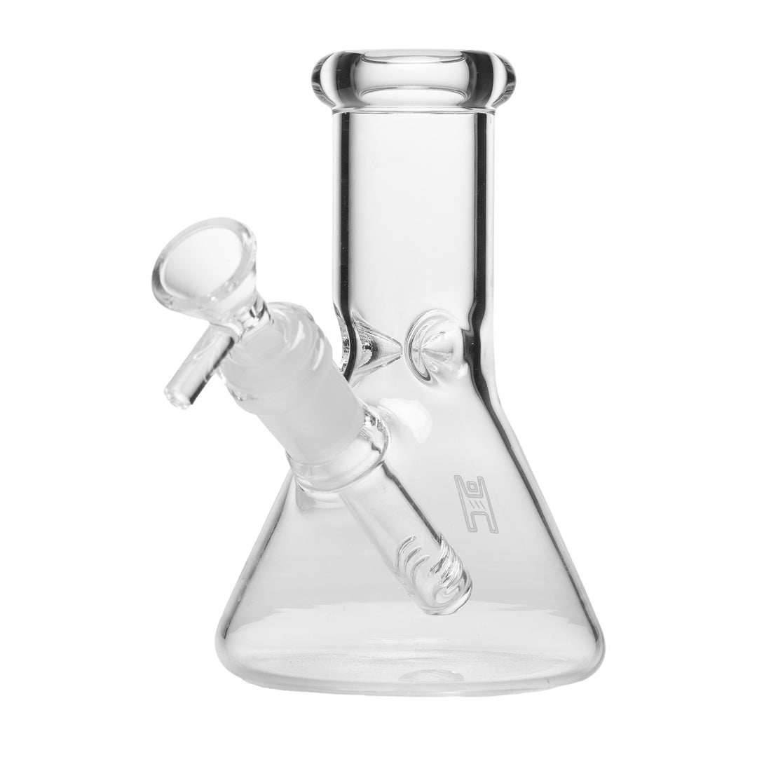 Human Grade 6" Beaker Water Pipe in Clear, angled from the left, showing the wide beaker base and the ice catcher pinches in the neck