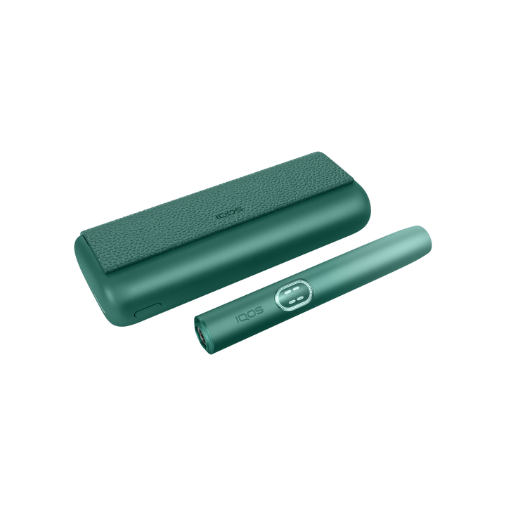 IQOS ILUMA i PRIME Aspen Green closed pocket charger lying flat with the holder beside it