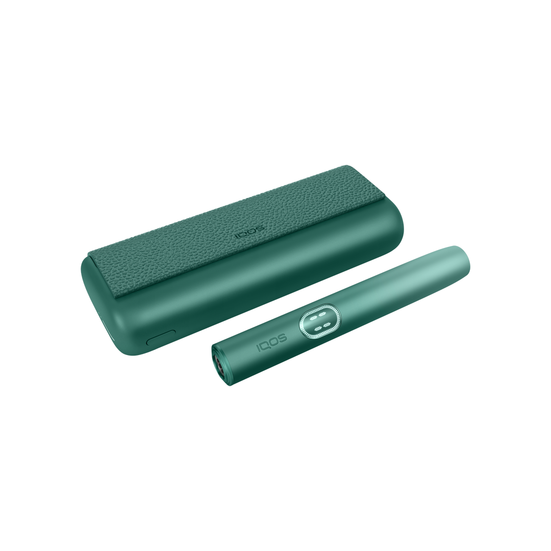 IQOS ILUMA i PRIME Aspen Green closed pocket charger lying flat with the holder beside it
