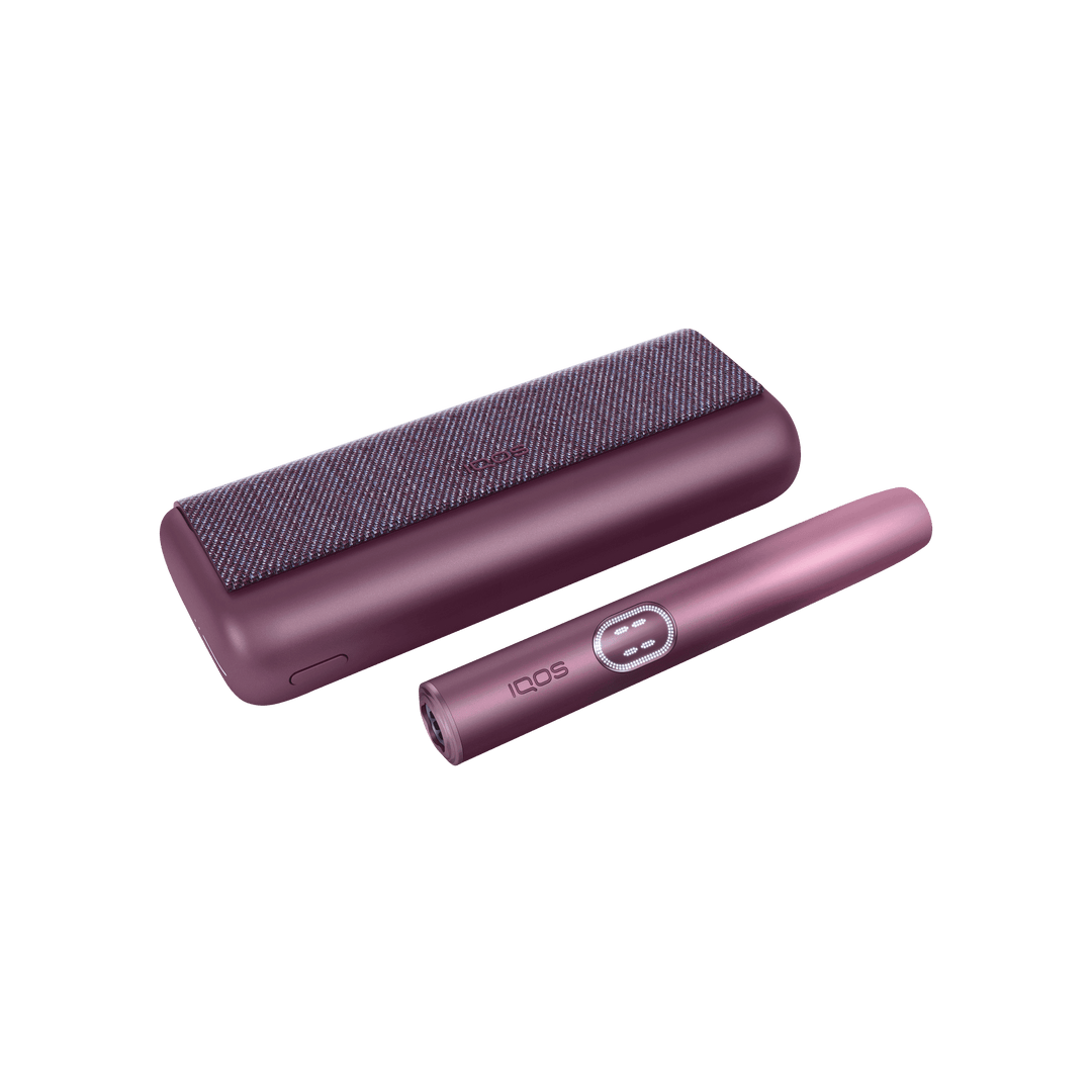 IQOS ILUMA i PRIME Garnet Red closed pocket charger lying flat with the holder beside it