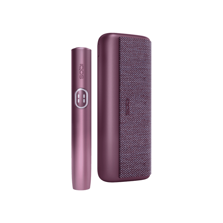 IQOS ILUMA i PRIME Garnet Red holder standing beside the closed pocket charger, front view