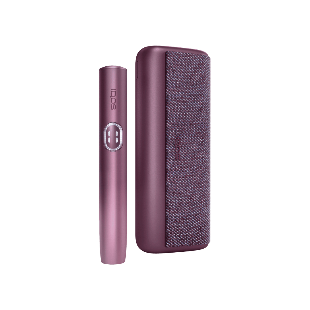 IQOS ILUMA i PRIME Garnet Red holder standing beside the closed pocket charger, front view