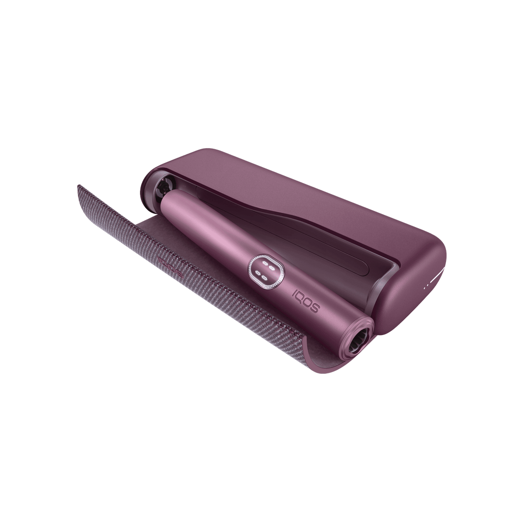 IQOS ILUMA i PRIME Garnet Red pocket charger with the wraparound cover open and the holder docked inside