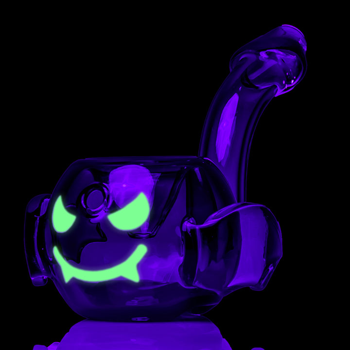 MJ Arsenal Bud-Sucker Hand Pipe under black light, three-quarter view from the other side