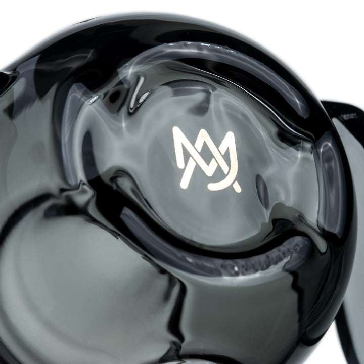 Close-up of the MJ Arsenal logo in the bottom of the Bud-Sucker Hand Pipe bowl