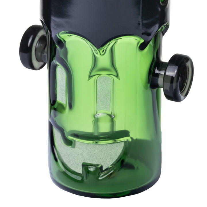 Close-up of the MJ Arsenal Frankenbubbler monster face, rectangular eyes and grin in the green glass