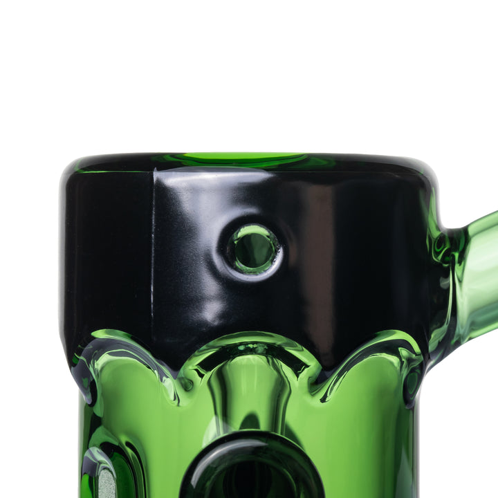 Close-up of the MJ Arsenal Frankenbubbler black flat top dripping over the green glass, with the carb hole