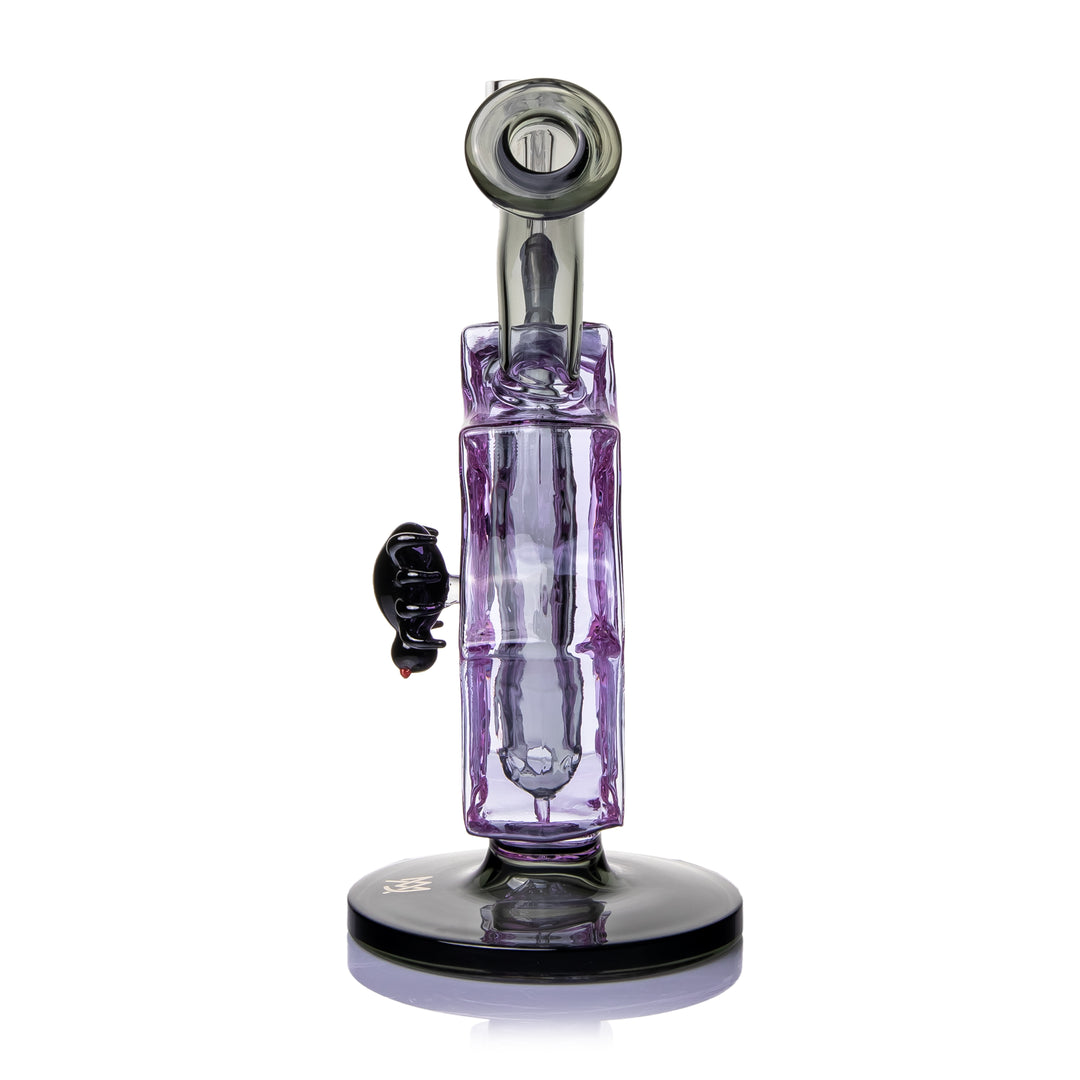 MJ Arsenal Nightcrawler Mini Dab Rig side view from the mouthpiece end, showing the angled smoke-colored mouthpiece with its black accent ring and the weighted round black foot