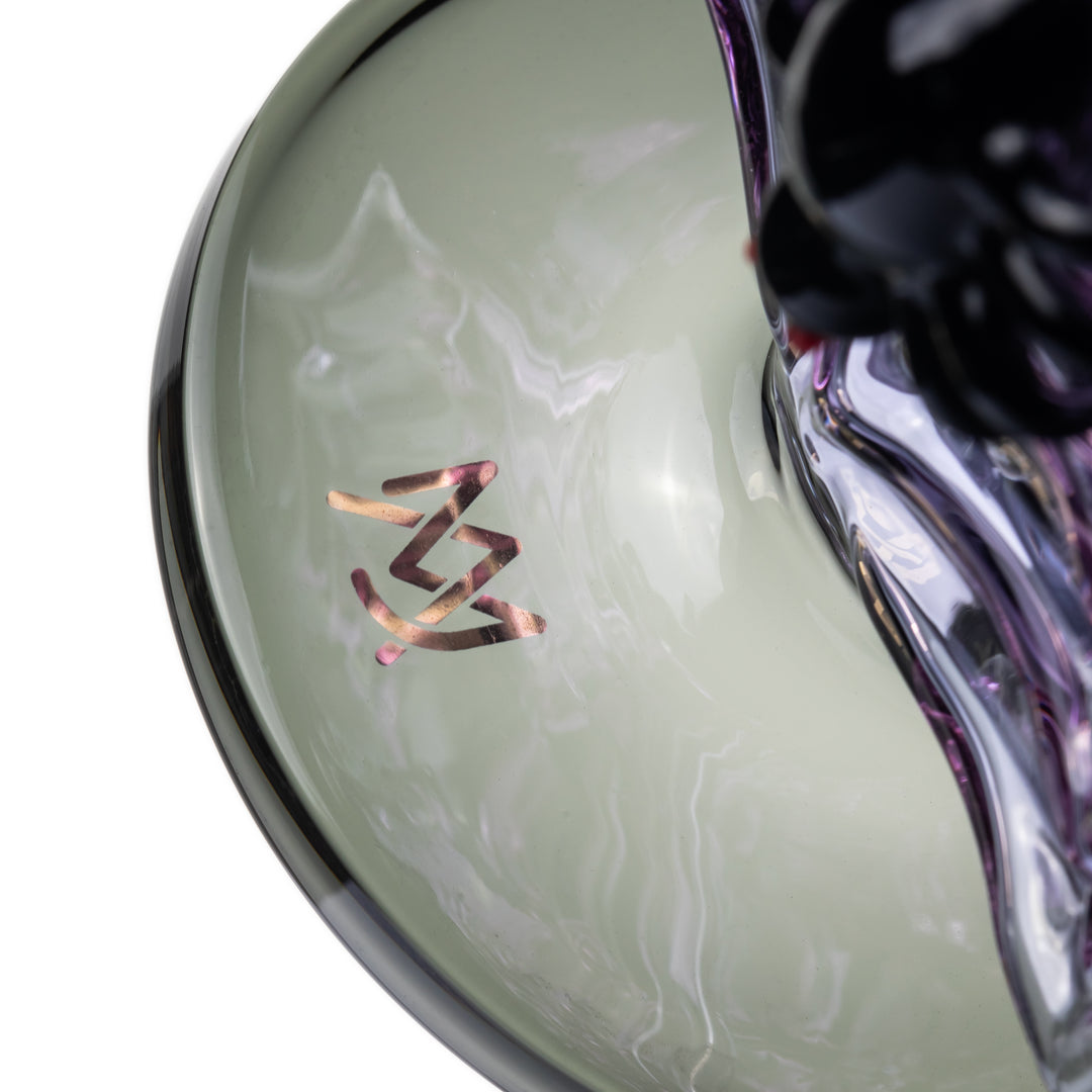 Close-up of the MJ Arsenal logo on the smoke glass of the Nightcrawler Mini Dab Rig