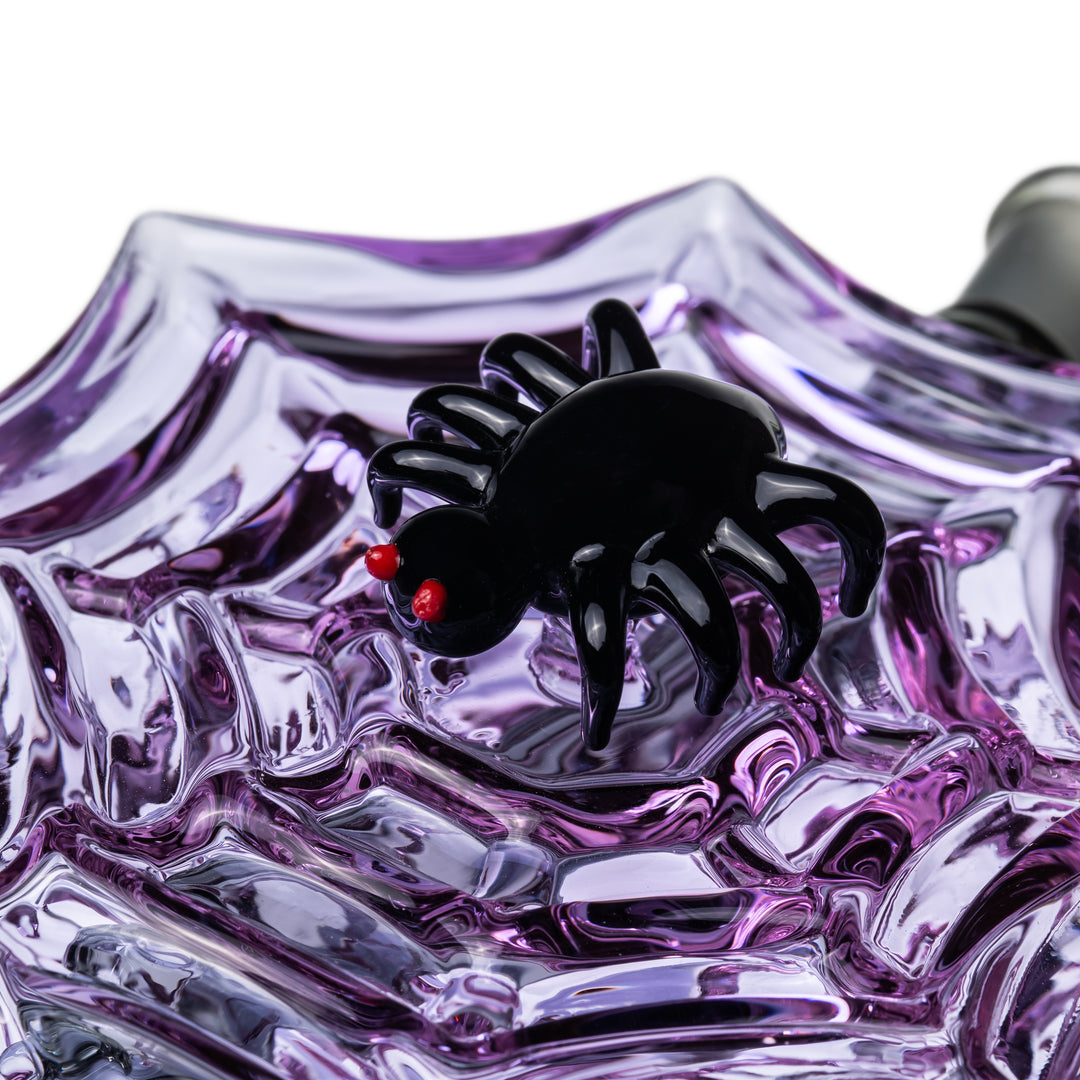 Close-up of the black sculpted spider with red eyes on the Nightcrawler Mini Dab Rig purple web