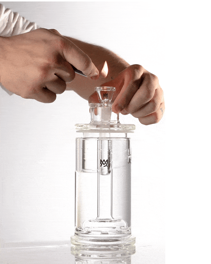 MJ Arsenal Piston Gravity Bong in use, core lifting to draw smoke into the chamber.