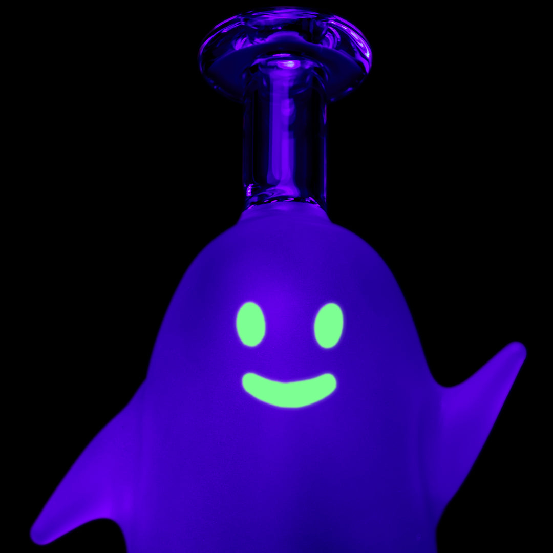 Close-up of the MJ Arsenal Specter Peak Top under black light, the glowing ghost face and smile