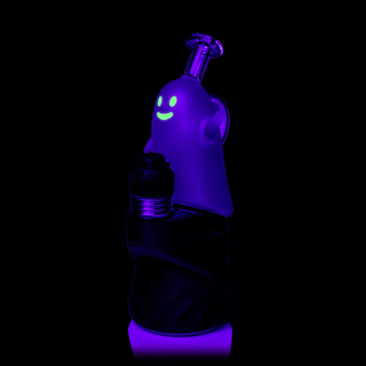 MJ Arsenal Specter Peak Top glowing under black light, fitted on a Puffco Peak, three-quarter view