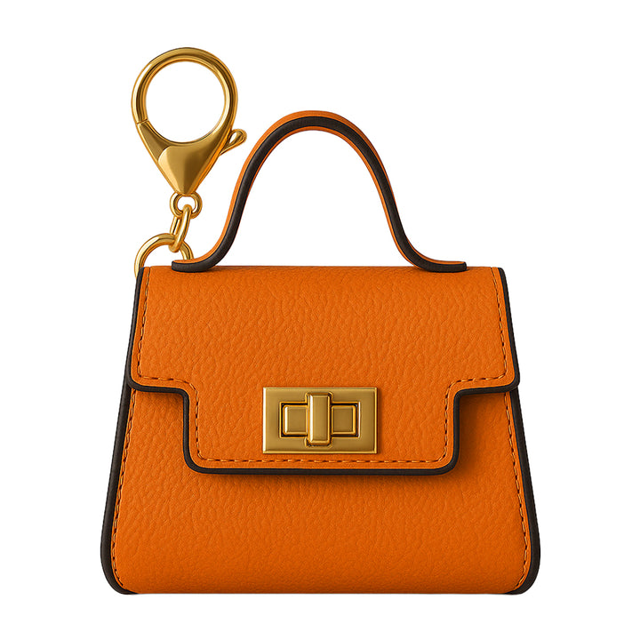 Close-up of Orange Pursejamin purse-shaped vape battery with gold accents