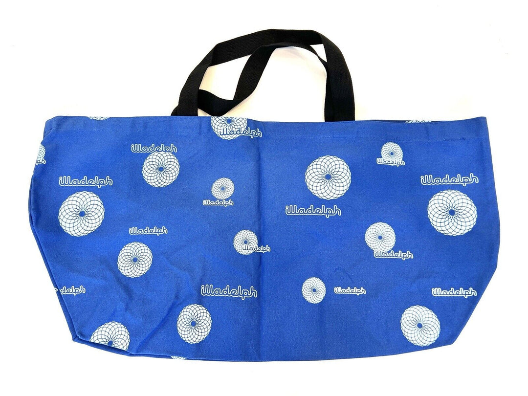 Illadelph tote bag in blue with all-over white spiral print and dual black shoulder straps. Stylish and functional accessory for everyday use.