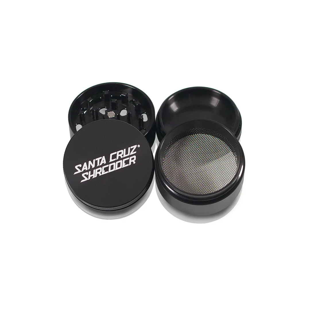 Four sections of the Black Santa Cruz Shredder 4-Piece Medium Grinder arranged flat.