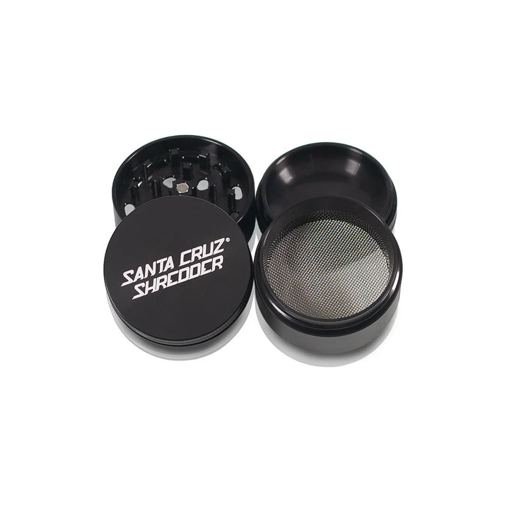 Four sections of the Black Santa Cruz Shredder 4-Piece Medium Grinder arranged flat.