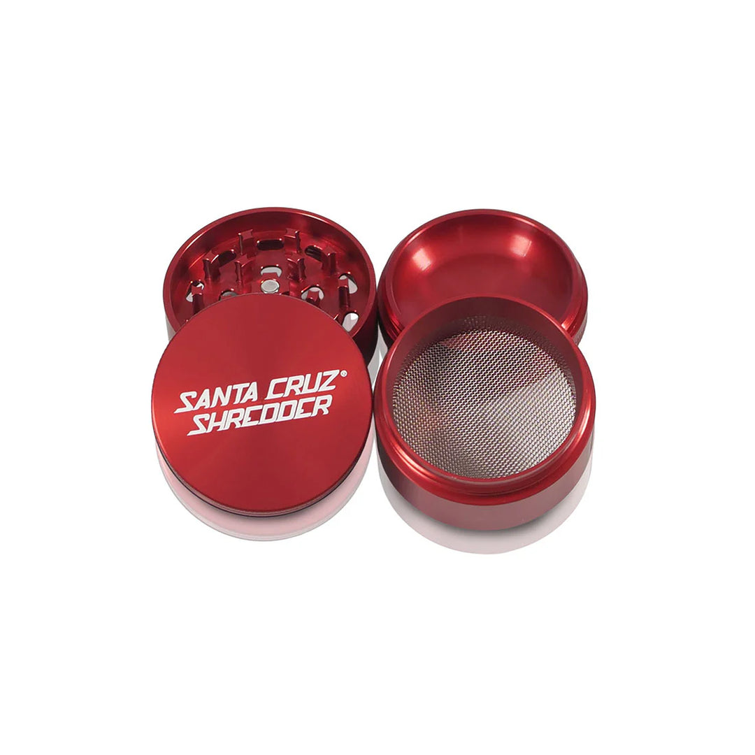 Four open parts of the Red Santa Cruz Shredder 4-Piece Grinder laid out.
