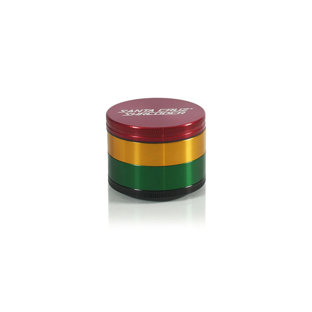 Rasta Santa Cruz Shredder grinder in red-yellow-green anodized finish with logo on lid