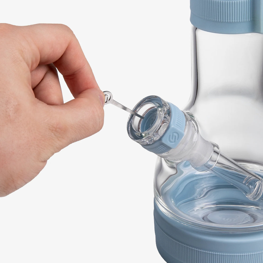 Close-up of the metal tool slotted into the Cerulean silicone neck sleeve of the Softglass Core Bong