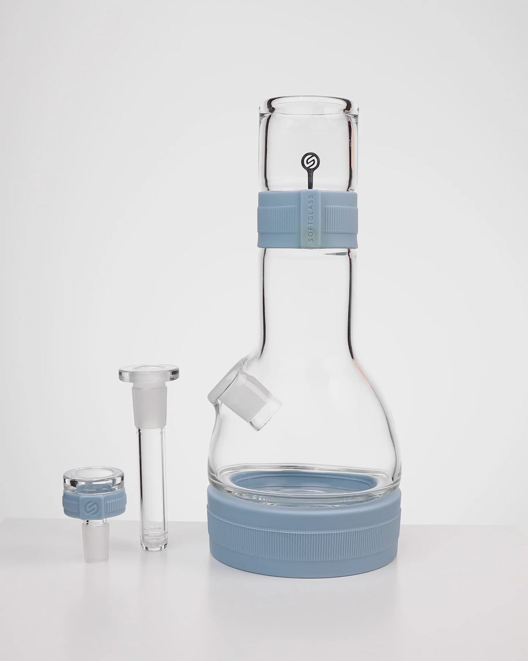 Softglass Core Bong in Cerulean shown disassembled: glass body with silicone neck band and base foot, removable 4 inch downstem, and 14mm flower bowl with its silicone grip collar