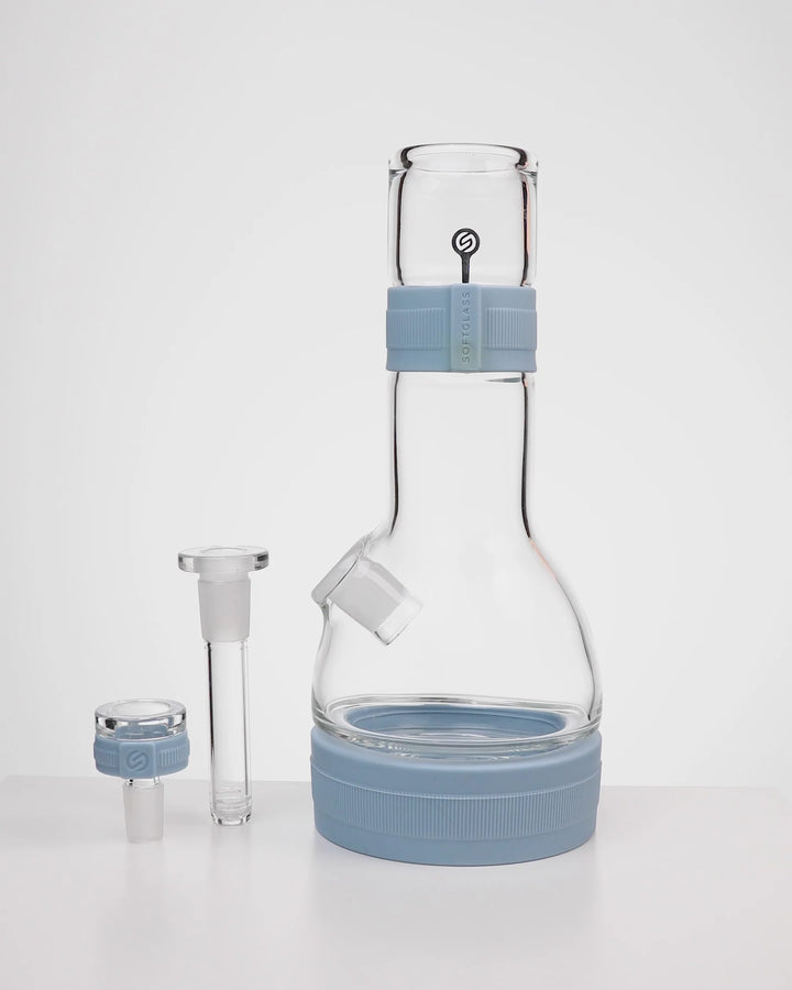 Softglass Core Bong in Cerulean shown disassembled: glass body with silicone neck band and base foot, removable 4 inch downstem, and 14mm flower bowl with its silicone grip collar