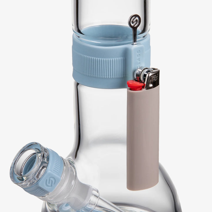 Detail of a lighter held by the magnetic Cerulean silicone neck band on the Softglass Core Bong