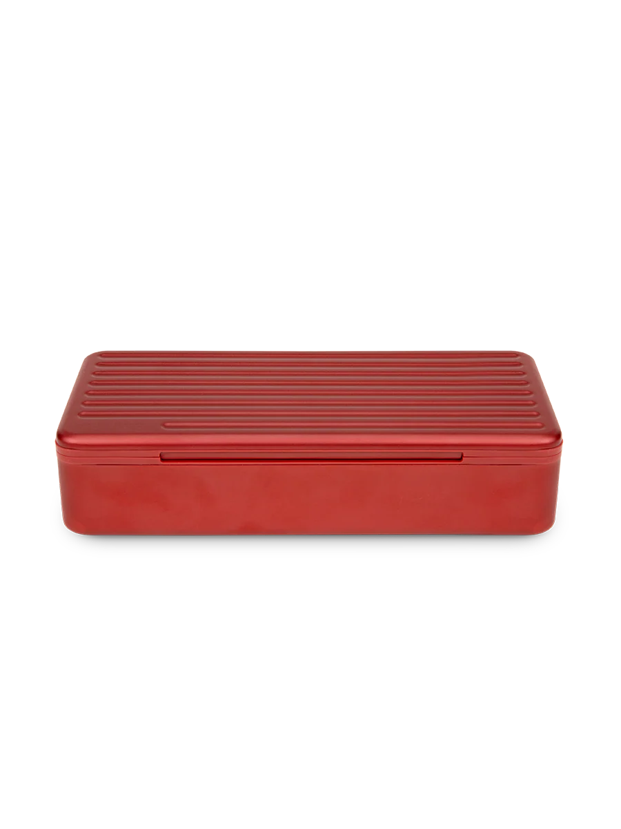Puffco Travel Case in Daybreak – red hard shell aluminum storage case closed, angled front view.