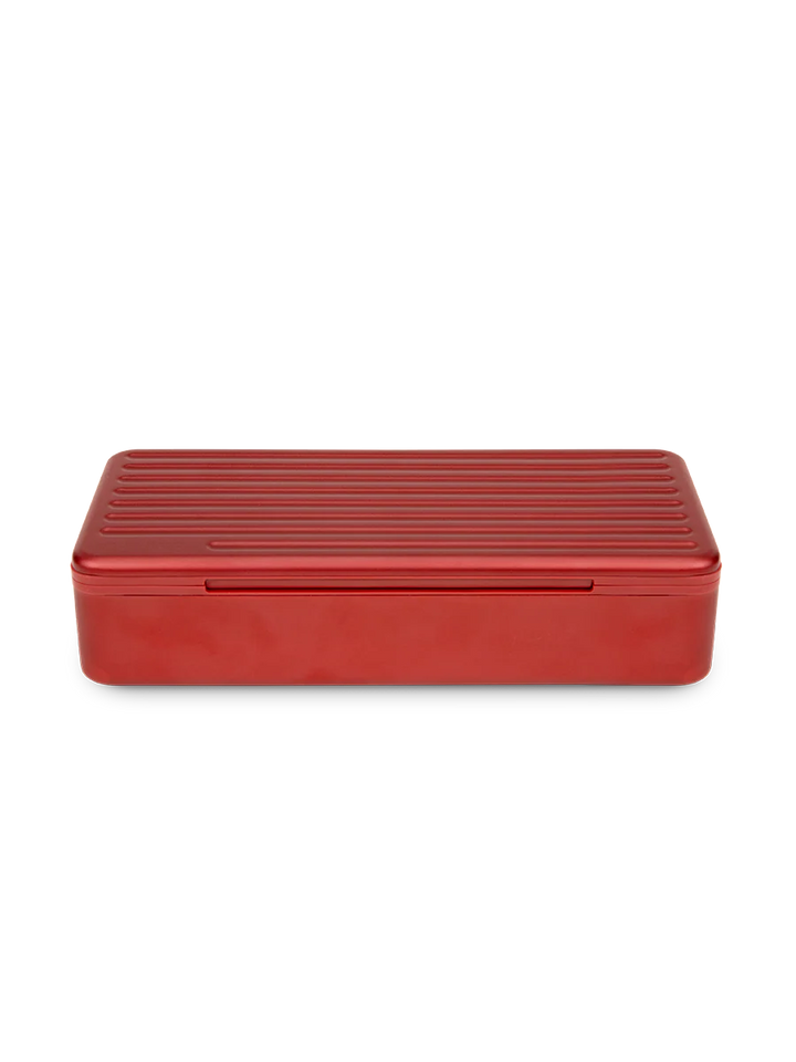 Puffco Travel Case in Daybreak – red hard shell aluminum storage case closed, angled front view.